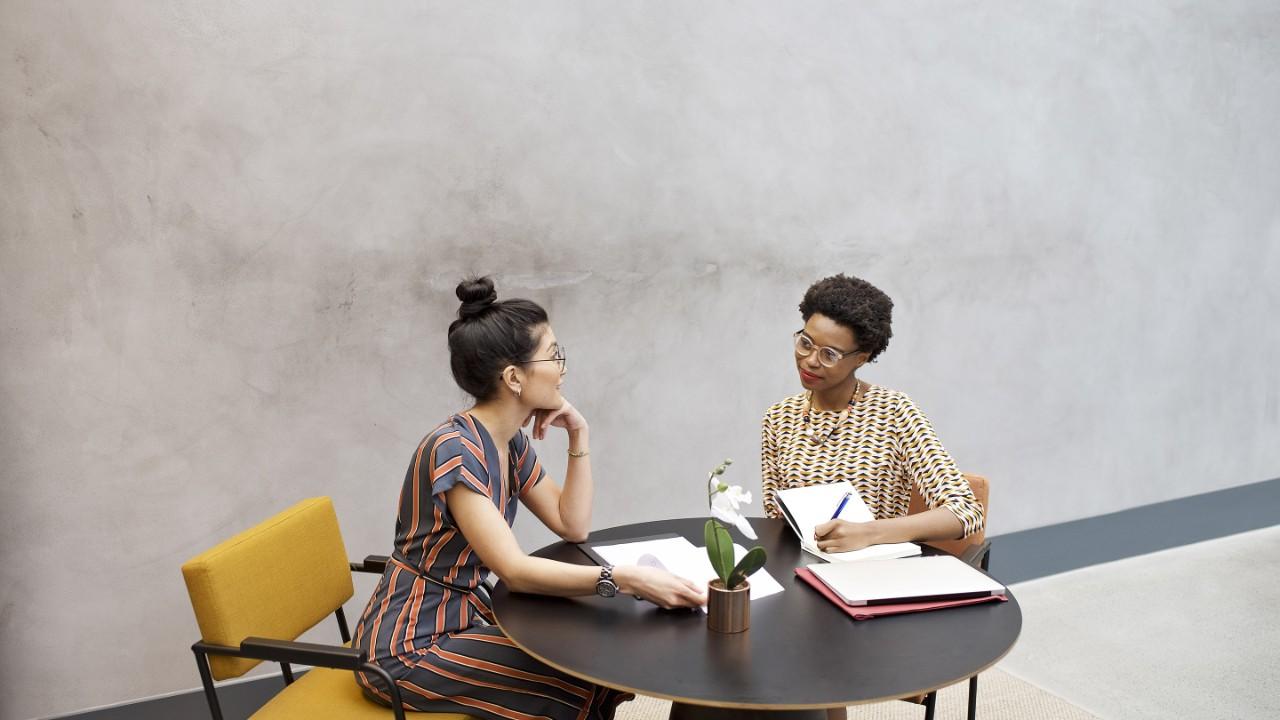 Black African and Asian businesswomen in a meeting